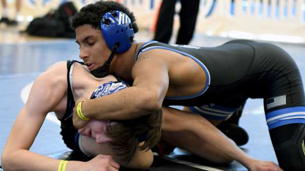 South Dade’s Luis Acevedo works his way to a tech fall win in a 120-pound match against Mark Bofantae of Wellington Community on Saturday at the FHSAA Duals wrestling state championships at Osceola High School.